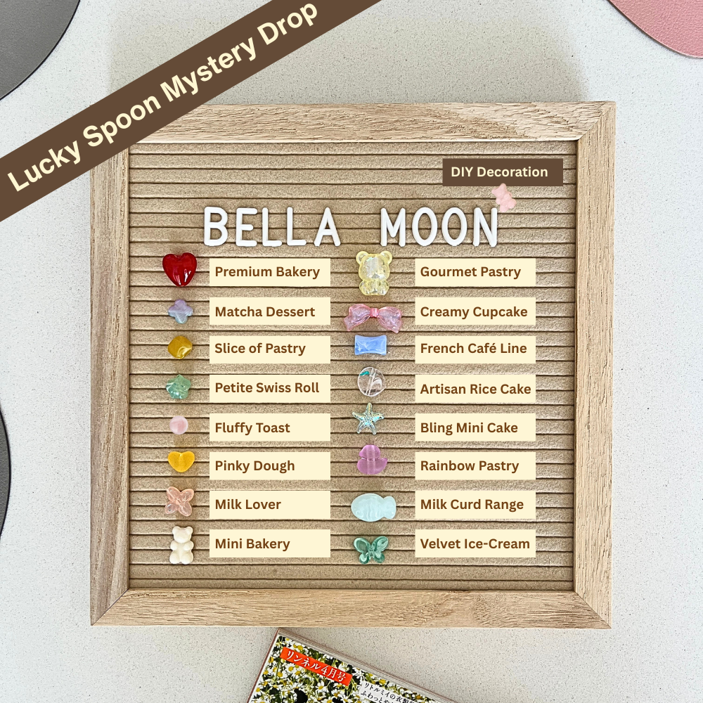 Wooden board with decorative elements and text, featuring 'BellaMoon Taba Squishies' and various pastry names.