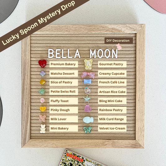 Wooden board with decorative elements and text, featuring 'BellaMoon Taba Squishies' and various pastry names.
