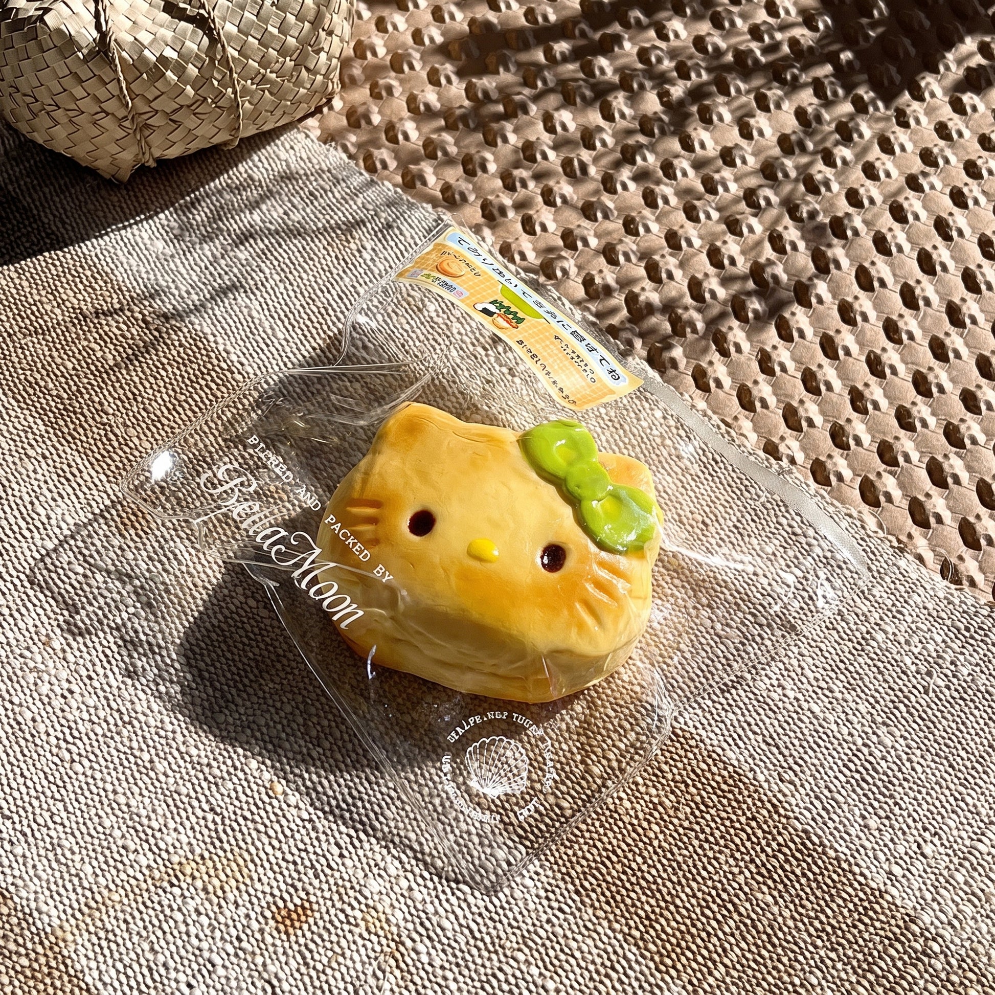 Golden brown charcoal-grilled Hello Kitty bun TABA squishy with matcha bow and toasted whisker details, handmade slow rising stress relief squishy Australia Sydney
