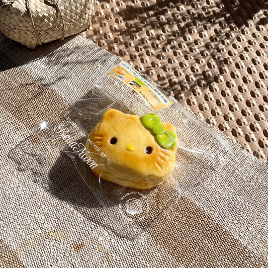 Golden brown charcoal-grilled Hello Kitty bun TABA squishy with matcha bow and toasted whisker details, handmade slow rising stress relief squishy Australia Sydney