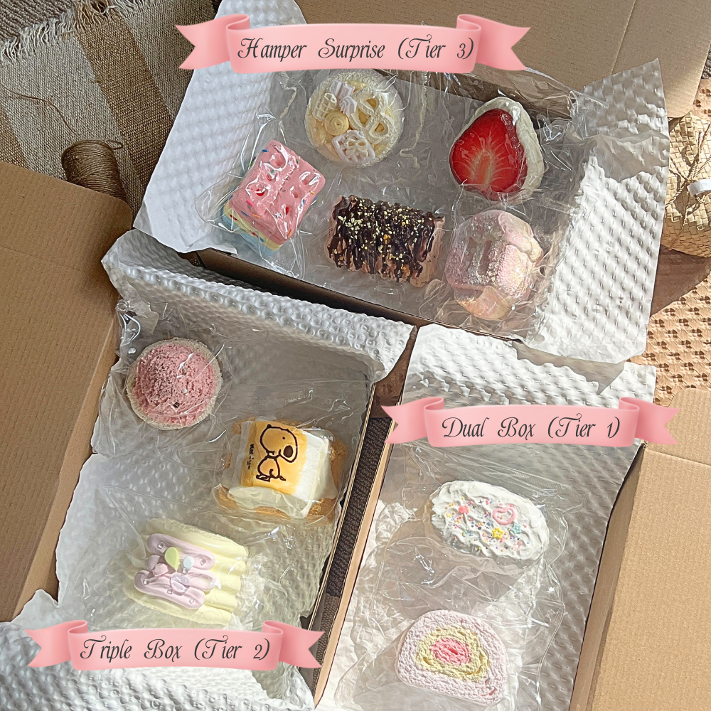 Three boxes containing various small taba squishies with different textures and packed with decorative packaging.